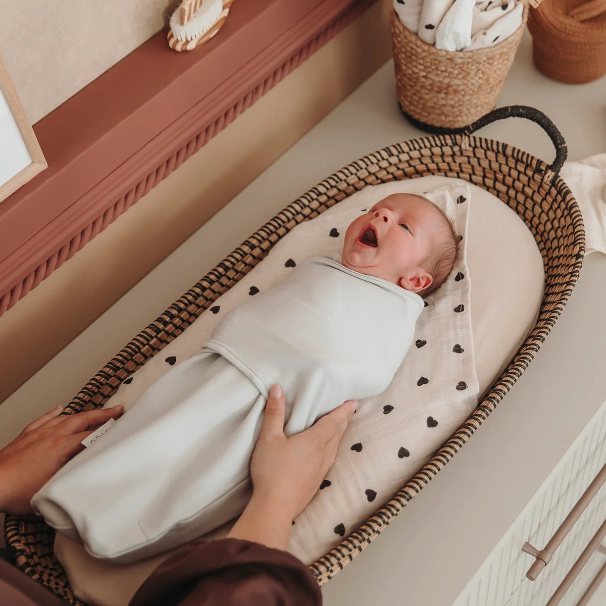 Zdjęcie poglądowe Meyco SwaddleMeyco – dziecko w jasnym otulaczu; kolor inny niż oferowany Grey
